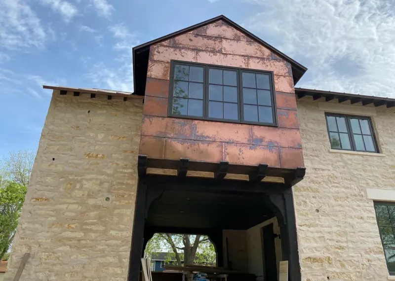 Copper metal panel facade on a stone building for Skylight Installation in Hayward